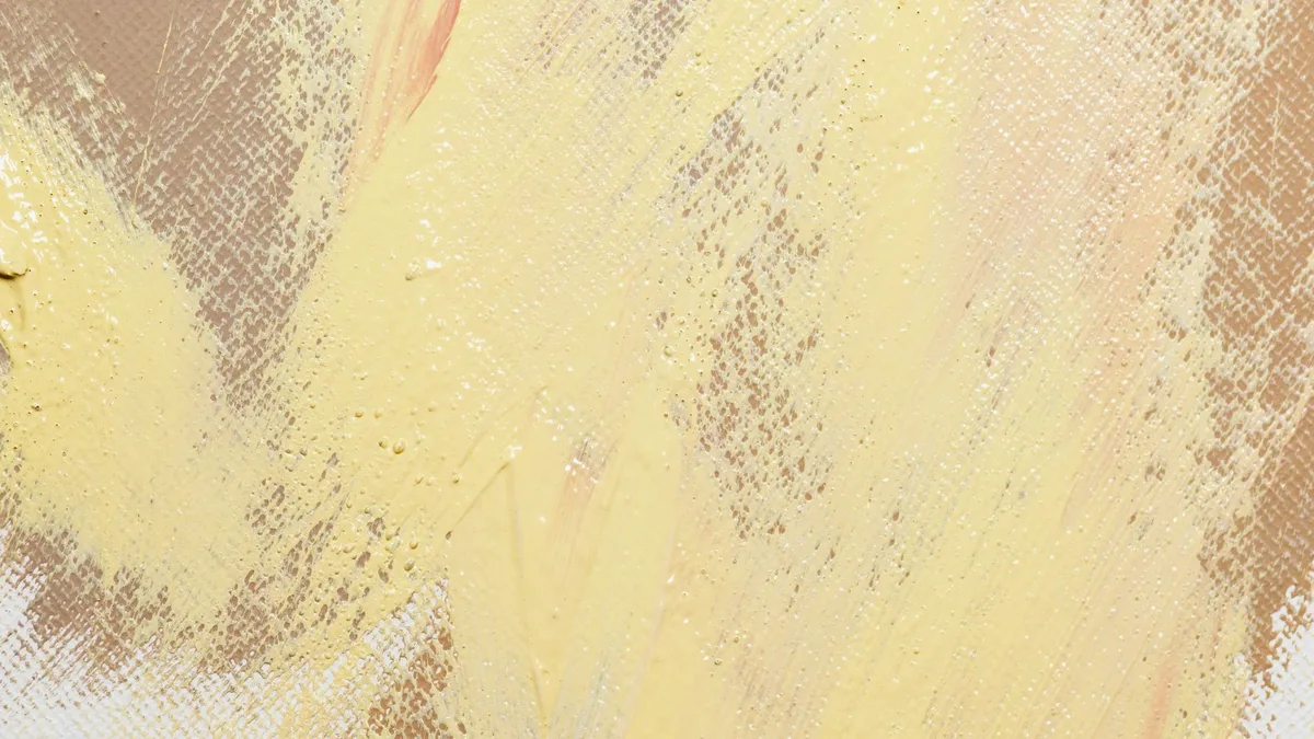 Composition de couleurs douces associant ocre, blanc cassé et beige sur textiles et surfaces.