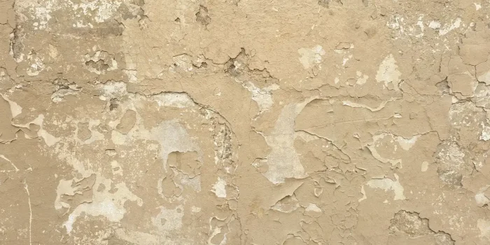 Mur peint en ocre avec textures naturelles et lumière douce mettant en valeur la richesse chromatique de la teinte.