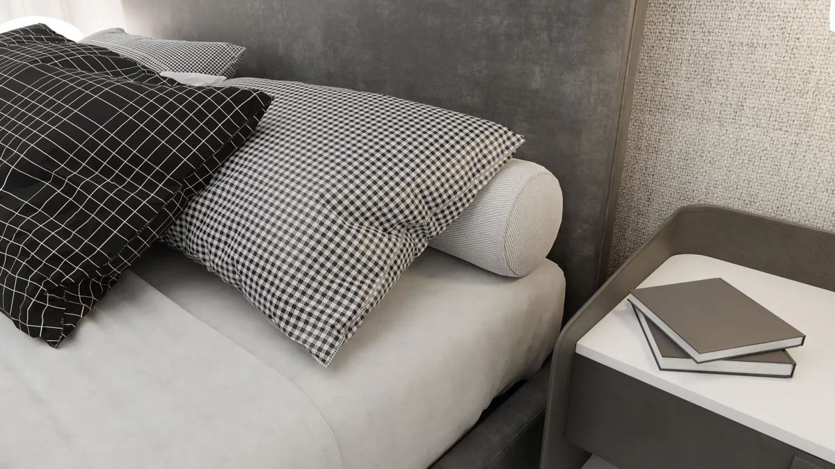 Traversin positionné contre la tête de lit dans une chambre épurée