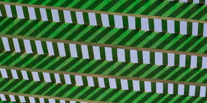 Terrasse ombragée avec voile d'ombrage et pergola créant des zones d'ombre sur le sol