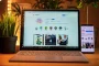 Mains anonymes tenant un smartphone au-dessus de croquis UX et d'un ordinateur portable