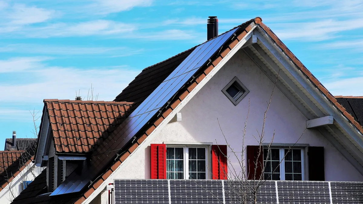 Installateur examinant une toiture avant pose de panneaux solaires